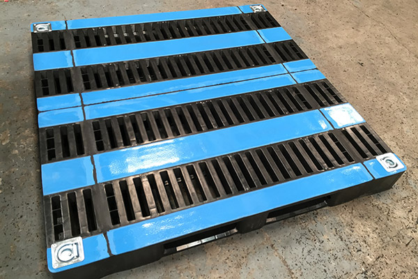 A modified plastic pallet on a factory floor.