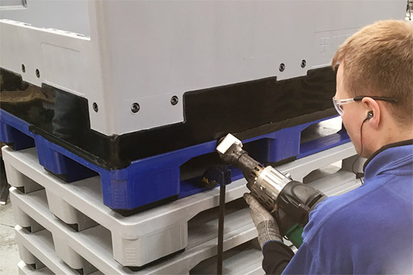 A worker welding plastics together in a UK factory.