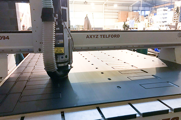 A CNC machine fabricating plastic components at a facility in the United Kingdom.