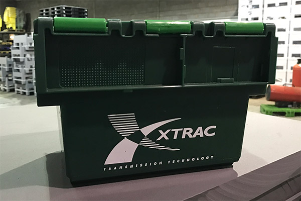 A plastic transport box with printed branding.