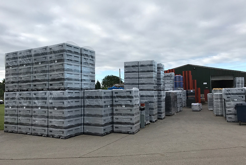 Stacks of new pallets and crates awaiting shipment to clients in the logistics and materials handling industry