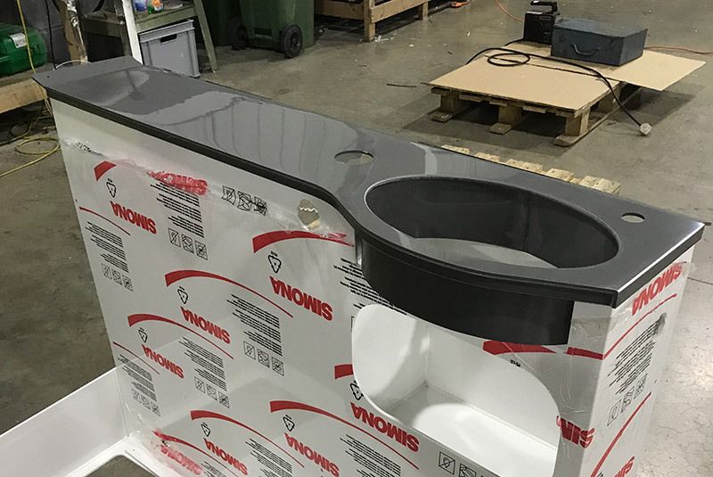 Plastic fabrication of complex components in a factory.